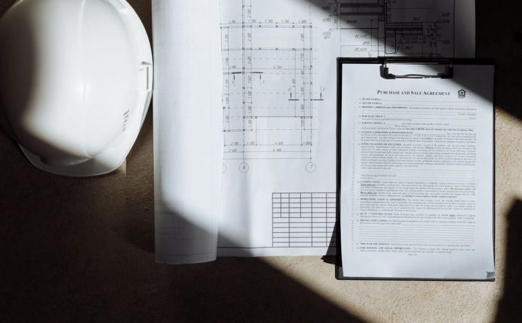 Aggiornamento catastale con DOCFA: i casi in cui serve davvero: Vista dall'alto di documenti di costruzione e casco alla…